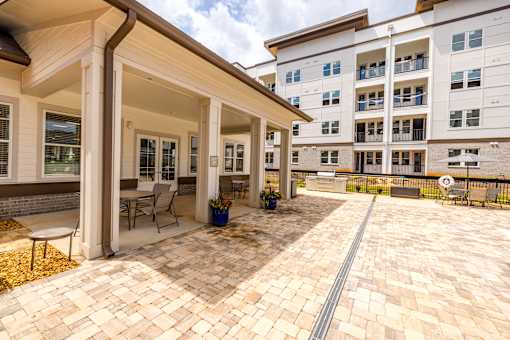 A patio area with a table and chairs is in front of a building.