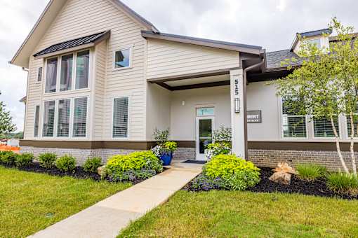 A house with a front yard and a walkway leading to the front door.