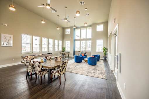 A dining room with a table set for six.