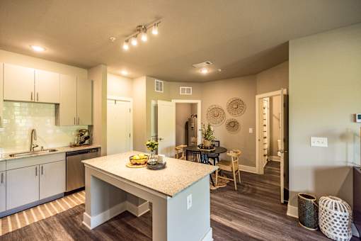 A kitchen with a table and chairs in the middle of the room.