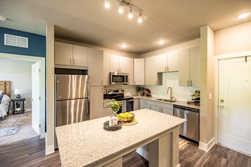 A kitchen with a table in the middle of it.