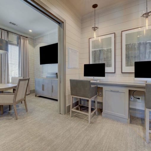 a room with a desk and chairs and a television at Citadel at Westpointe, San Antonio