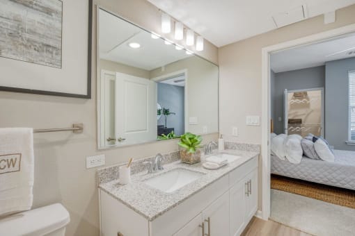 a bathroom with two sinks and a large mirror at Citadel at Westpointe, Texas, 78251