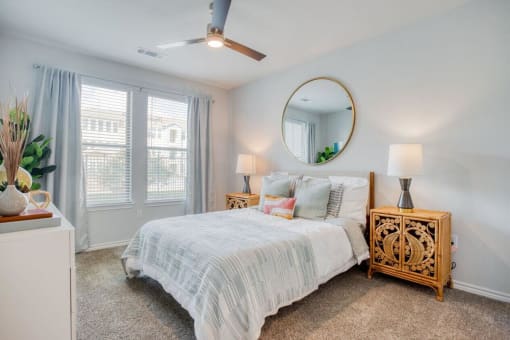 a bedroom with a bed and a mirror  at Edge and Stone, San Antonio