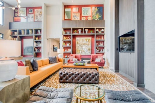 a living room filled with furniture and a book shelf  at Edge and Stone, San Antonio, 78260