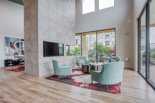 a living room with a couch and chairs and a tv  at Edge and Stone, Texas, 78260