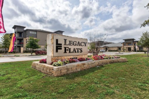 the sign for legacy flats in front of a building at Legacy Flats, San Antonio, TX 78254