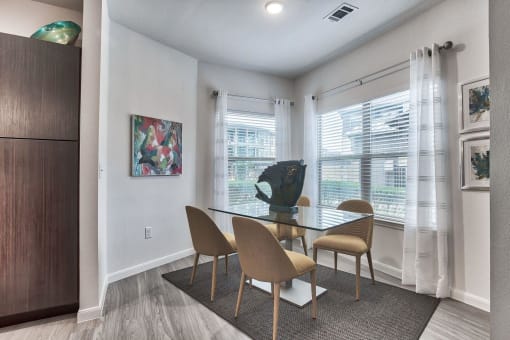 a dining room with a glass table and chairs at Legacy Flats, Texas