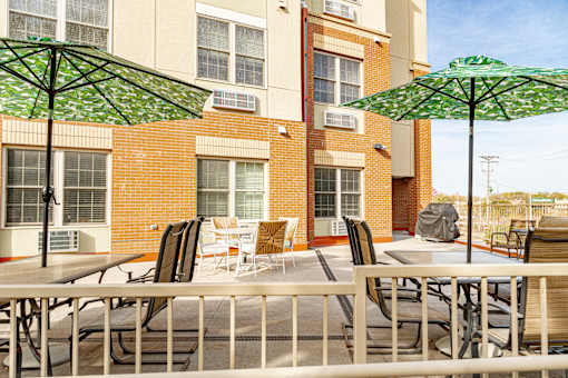 our apartments offer a patio with tables and chairs and umbrellas