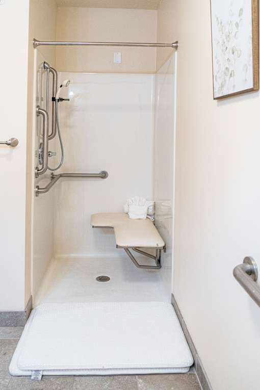 a small bathroom with a shower and a table in it