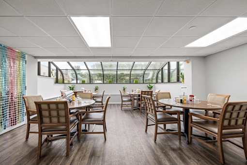 A conference room with a long table and chairs.