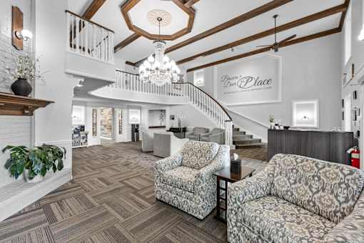 A living room with a staircase and a couch.