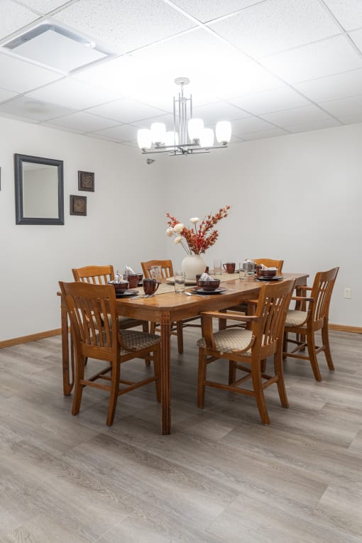 a dining room with a wooden table and chairs