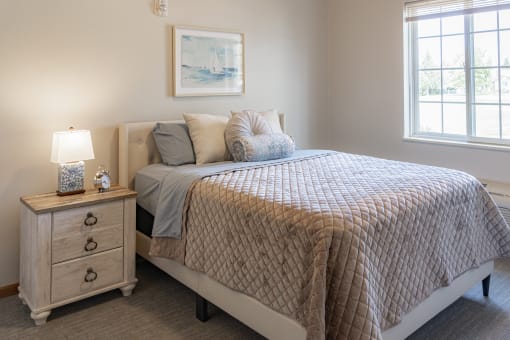 a bedroom with a bed and two windows