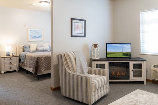 a living room with a couch and a tv and a bed