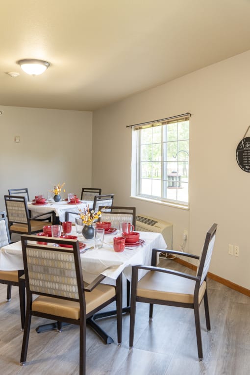 a dining room with tables and chairs and a window