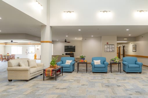 the lobby of the community center with couches and chairs