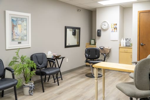 a waiting room at a physicians office with chairs and a table