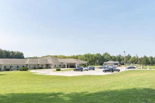 a parking lot with cars in front of a building
