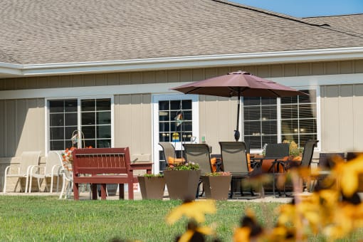 a patio with a table and chairs and an umbrella