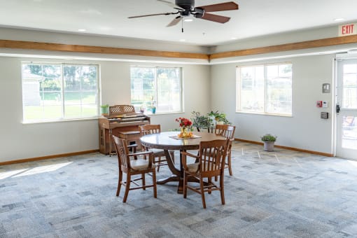 a dining room with a table and chairs and a piano