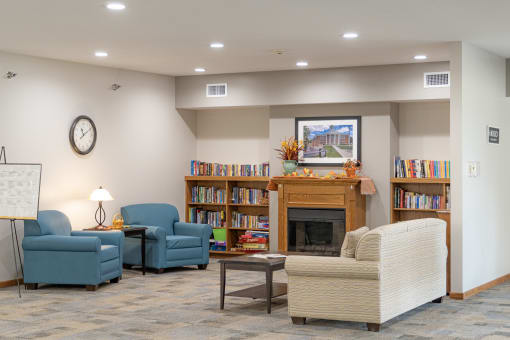 a living room with couches and chairs and a fireplace