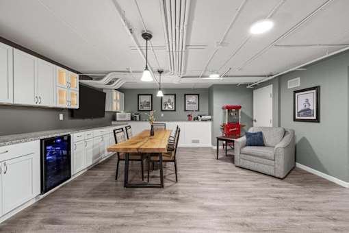 A kitchen with a dining table and chairs.