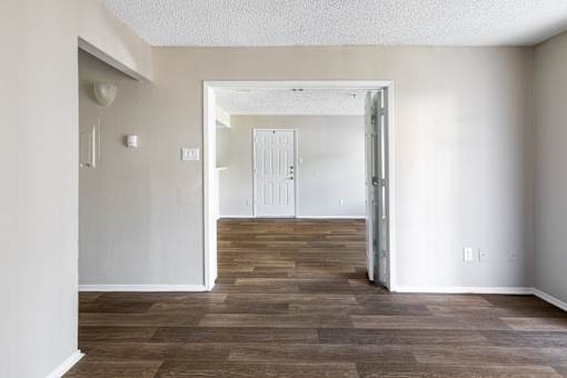 A room with a wooden floor and white walls.