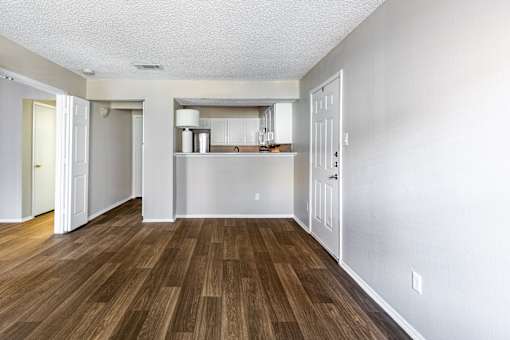 A room with wooden floors and white walls.