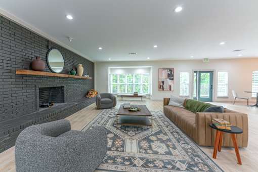 a living room with a couch and a chair and a fireplace