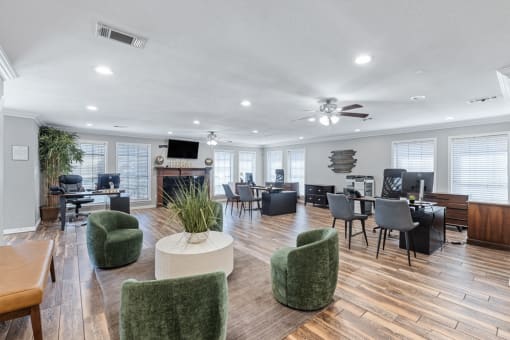 an open office space with green chairs and tables