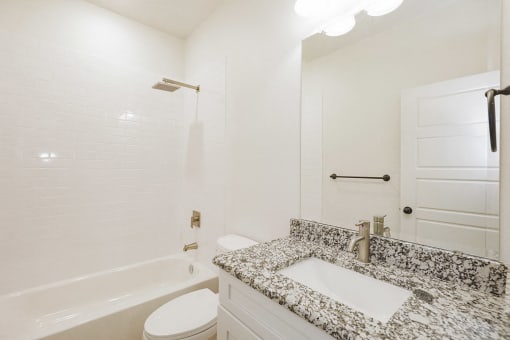 a bathroom with a sink and a tub and a toilet