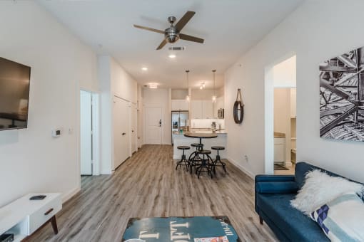 a living room with a couch and a ceiling fan