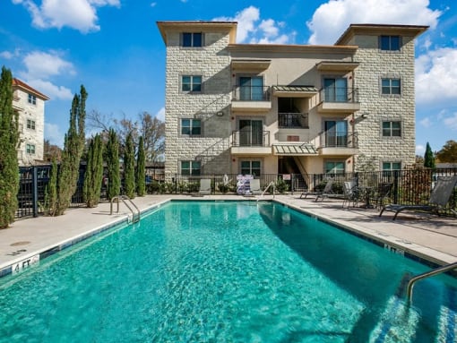 a large swimming pool in front of a building