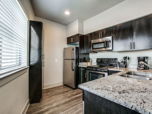 a kitchen with stainless steel appliances and granite counter tops