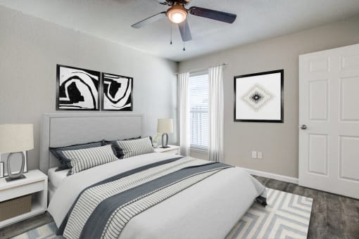 a bedroom with a large bed and a ceiling fan