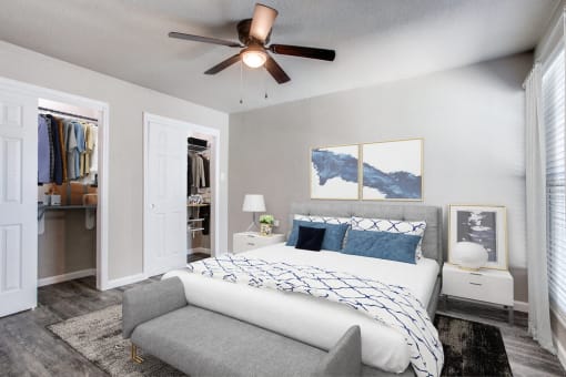 a bedroom with a bed and a ceiling fan