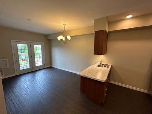 A room with a kitchenette and a window.
