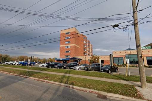 a parking lot with cars in front of a brick building