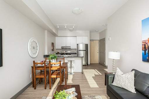 A modern kitchen with a dining table and a couch.
