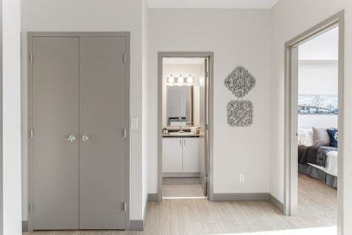 A grey double door is on the left of the image.