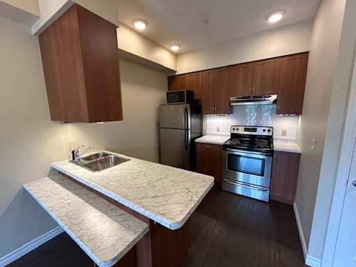 A kitchen with a stove top oven and a sink.