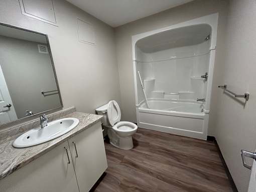 A bathroom with a sink, toilet, and bathtub.