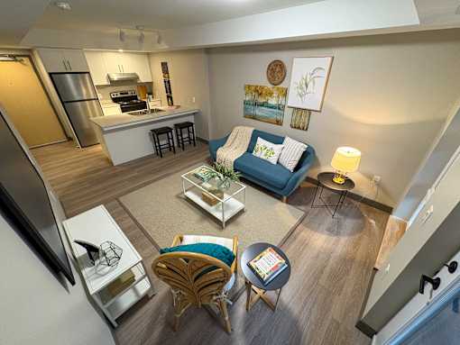 A living room with a blue couch and a white coffee table.