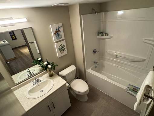A bathroom with a toilet, sink, and bathtub.