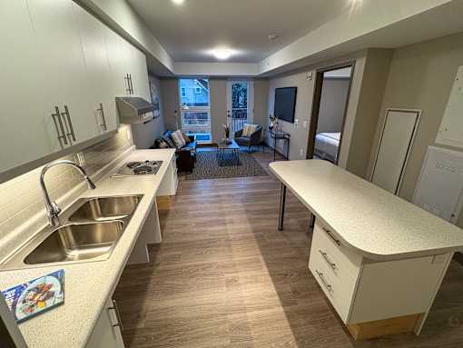 A kitchen with a sink and a counter.