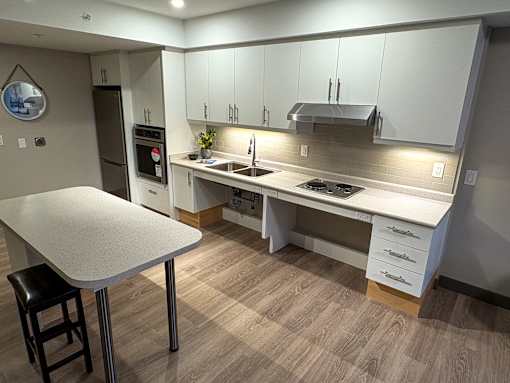 A modern kitchen with a table and chairs.