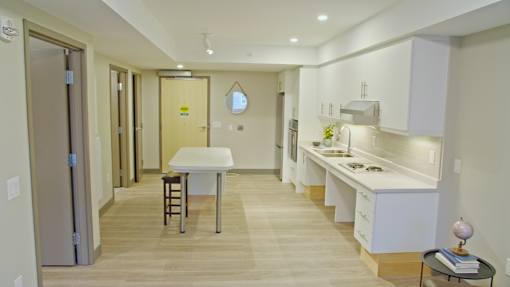 A kitchen with a table and chairs in the middle of the room.