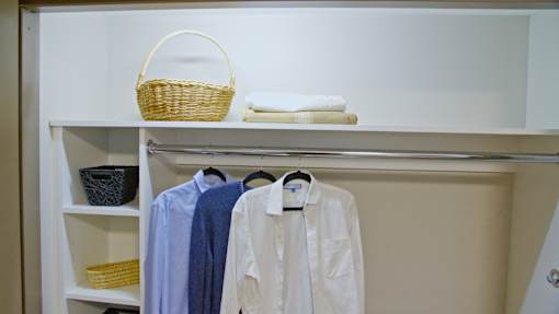 A white shirt is hanging on a hanger.