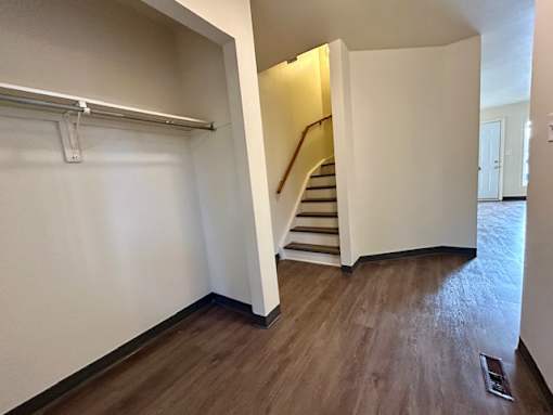 an empty room with a staircase and a white wall